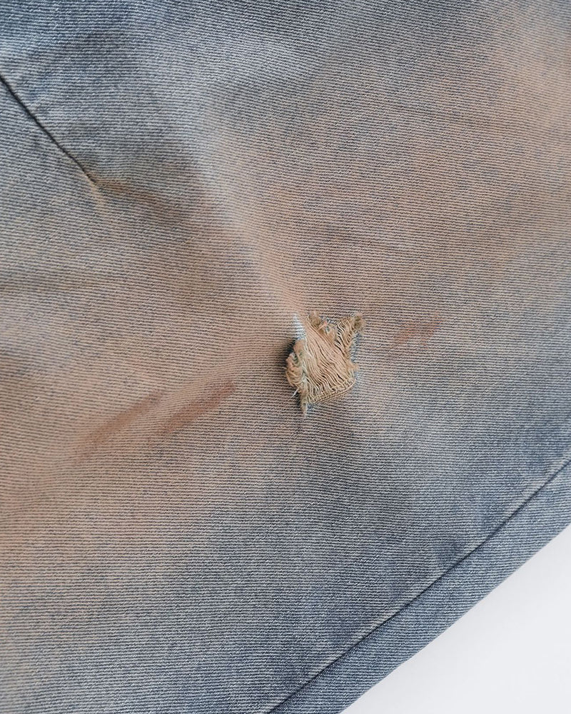 Distressed ripped denim trousers